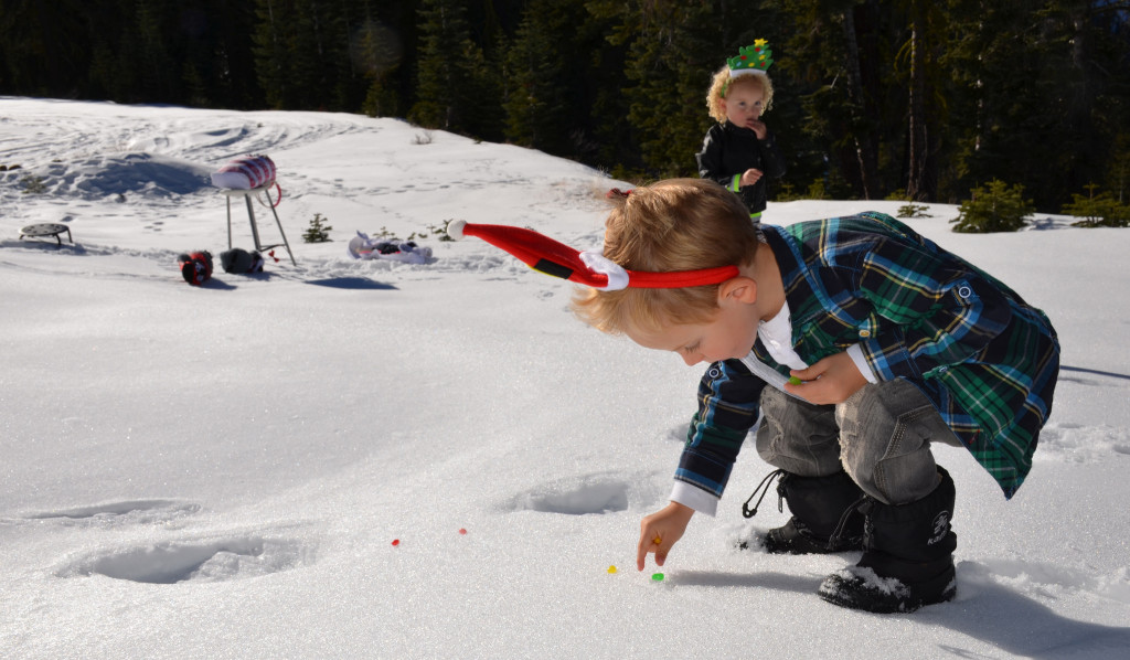 Collecting his scattered sweeties in the snow.