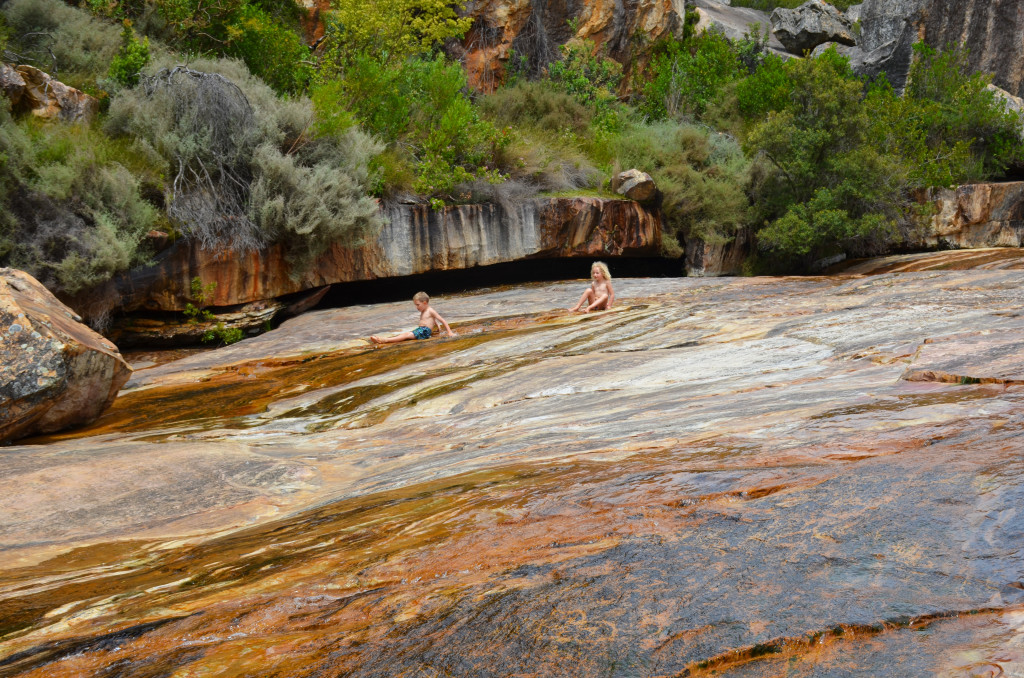 kids-sliding-with-rock